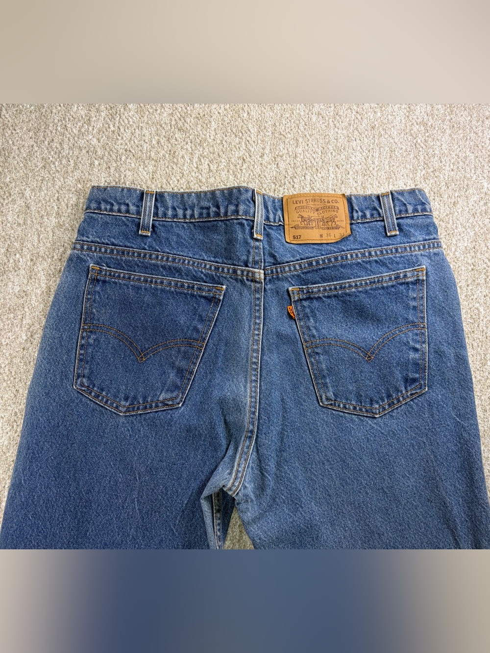 Vintage 90’s Levi's 517 bootcut jeans featuring an orange tab Made in USA